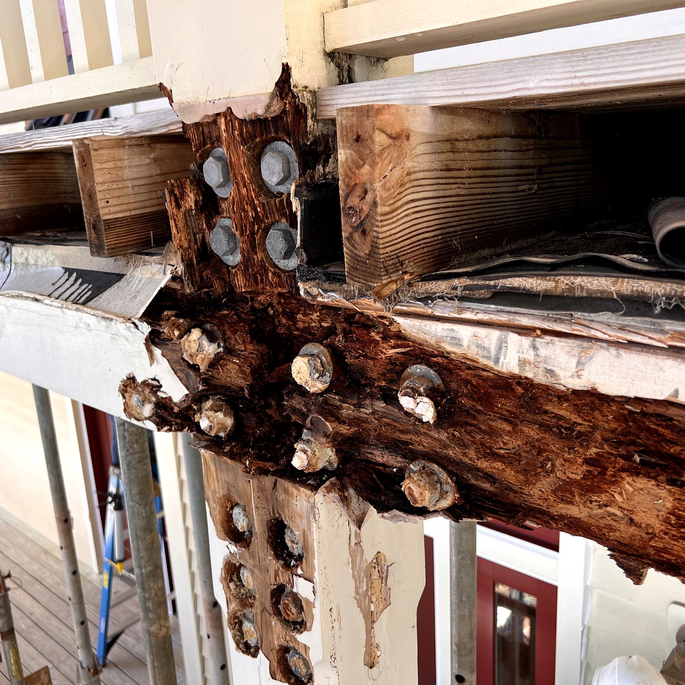 Balcony ledger board showing severe rot around the structural bolts on a coastal Florida home